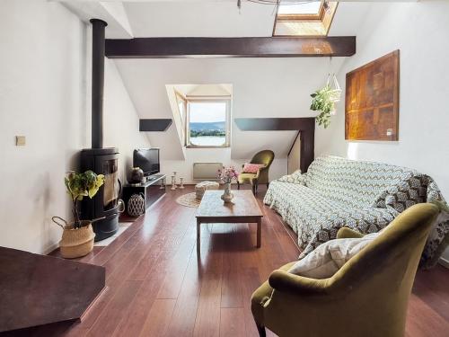 a living room with a couch and a table at Duplex face au lac d'Annecy in Veyrier-du-Lac