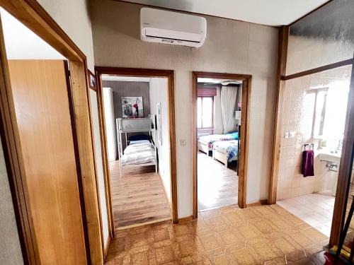 a room with two beds and a hallway with two mirrors at Villa Gianfranca - sentiti come a casa in Corno di Rosazzo