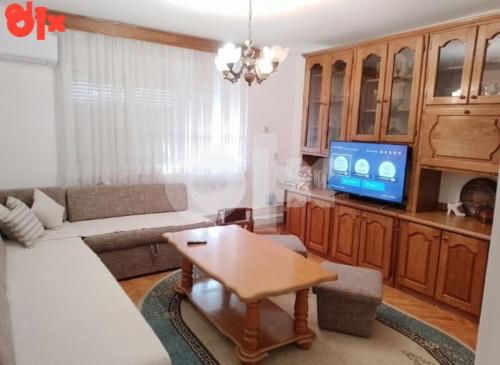 a living room with a couch and a tv at Apartman Čeliković in Bosanski Šamac