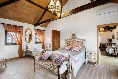 a bedroom with a bed and a tub and a sink at Casas da Chica com Piscina, Arouca in Espiunca