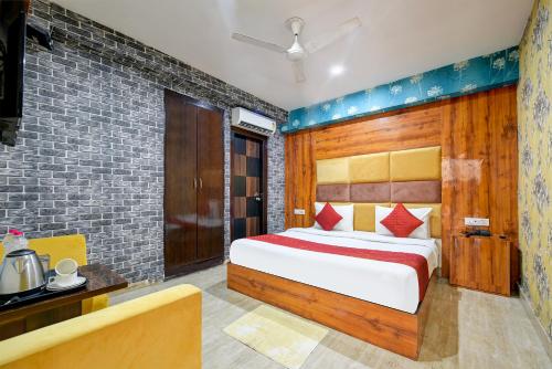 une chambre avec un lit et un mur de briques dans l'établissement Hotel The White Sand Suites, à New Delhi