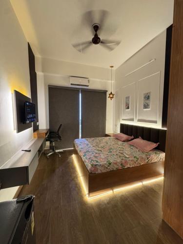 a bedroom with a bed and a ceiling fan at Heavenly stays in Greater Noida