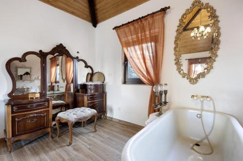 a bathroom with a tub and a vanity and a mirror at T5 com Piscina Casa da Chica in Espiunca