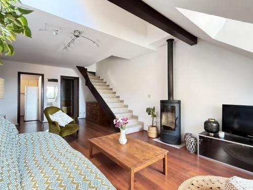 a living room with a bed and a fireplace at Duplex face au lac d'Annecy in Veyrier-du-Lac
