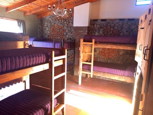 a room with two bunk beds in a cabin at Hostel Plataforma Home in El Bolsón