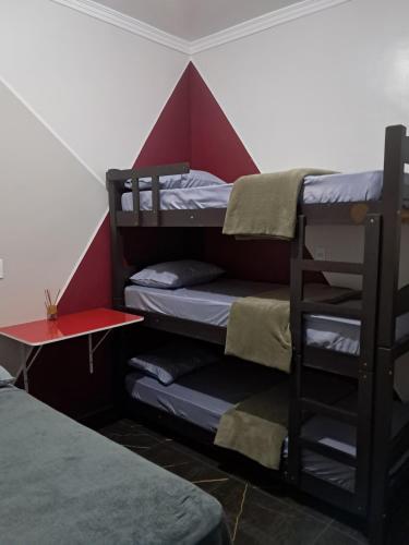 a room with three bunk beds in a tent at Quarto2 banheiro privativo externo in Guarulhos