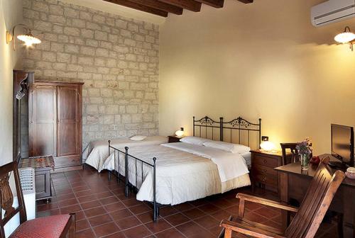 Cama ou camas em um quarto em Agriturismo Il Melograno