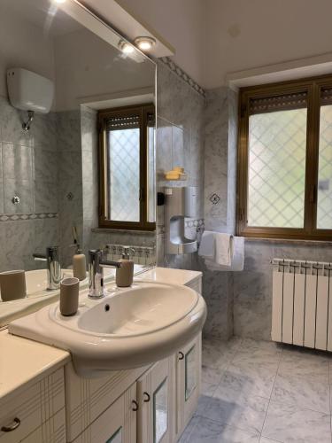 a bathroom with a sink and a large mirror at Da Chloe in Anagni