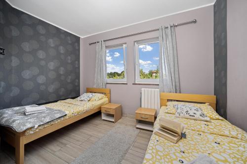 a bedroom with two beds and a window at Home DiE Paradise in Labin