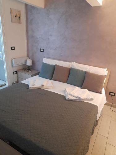 a bedroom with a large bed with two pillows at La Dimora Di Bruna in Naples