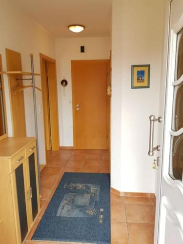 a hallway with a blue rug on the floor at Haus Kiki in Dornumersiel