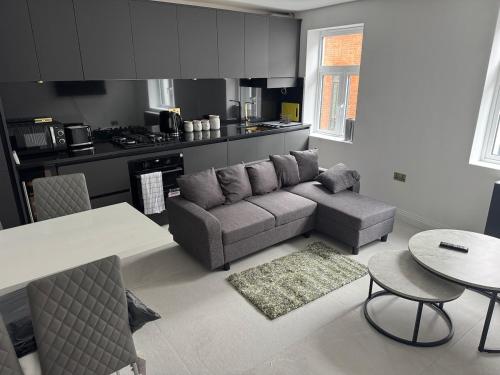 a living room with a couch and a table at Three-Bedroom Flat Located off Oxford Street in London