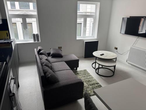 a living room with a couch and a table at Three-Bedroom Flat Located off Oxford Street in London
