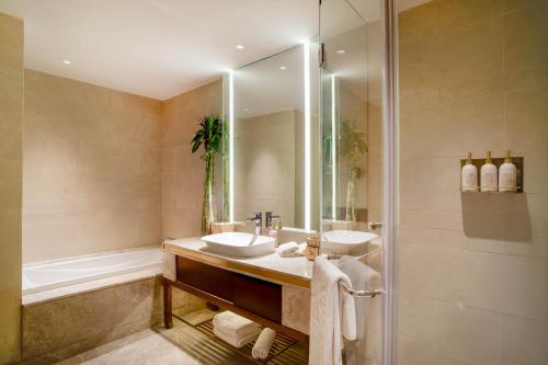 a bathroom with a sink and a shower at Taj Mussoorie Foothills, Dehradun in Dehradun