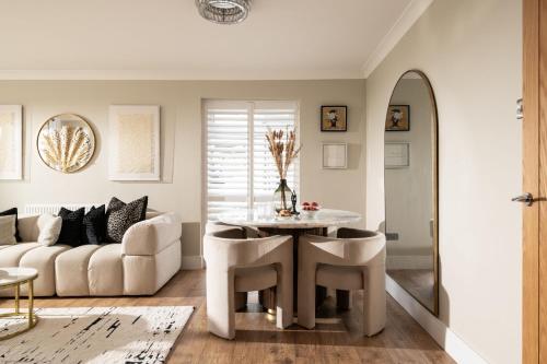 a living room with a table and chairs and a couch at Seahaven in Sandbanks in Poole