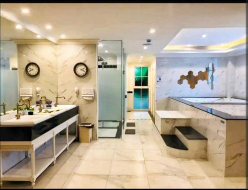 a bathroom with a shower and two sinks and a shower at Seven seas cote Apartment in Na Jomtien