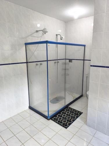 a shower with a glass enclosure in a bathroom at Farol dos Coqueiros in Angra dos Reis
