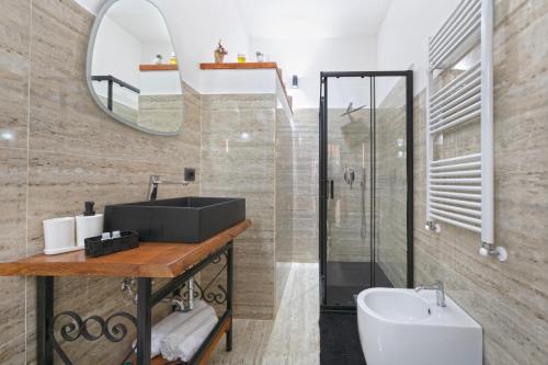 a bathroom with a sink and a mirror at Oasi di Edo e Memy - B&B, hot tub, sauna, A-C, near city center in Viterbo