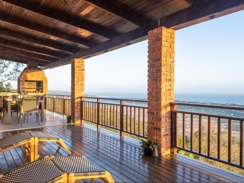 a balcony with a view of the ocean at Serpentine Views in Hoekwil