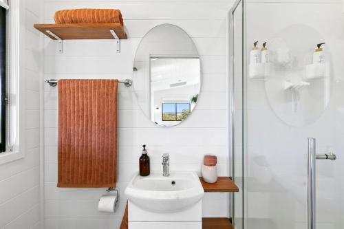 a bathroom with a sink and a mirror at The Bunker Malniri Park in Wilberforce