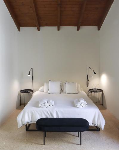 a bedroom with a white bed with two towels on it at Casa Brumar in Nardò