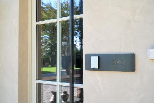 a sign on the side of a building with a window at Villa Bredina in Brescia