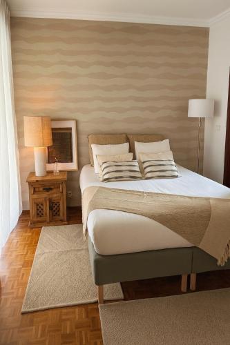 a bedroom with a bed and a table with a television at Soar Home l Airport l Olivais in Lisbon
