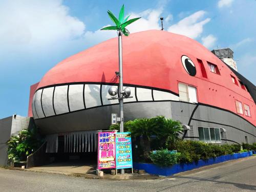 a domed building with a palm tree on top of it at Hotel Festa Qugiella -ホテル フェスタクジーラ- in Okayama