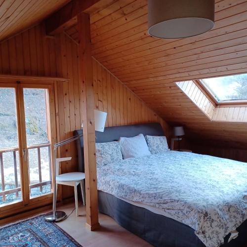 a bedroom with a bed in a wooden house at Chalet Rossier Mayens de Sion aux 4 Vallées in Agettes