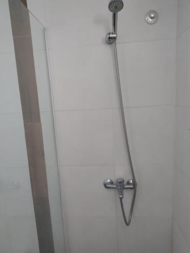 a shower stall with a shower head in a bathroom at Apart Atlántida I in Santa Clara del Mar