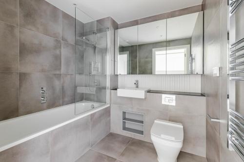 a bathroom with a toilet and a sink and a mirror at Blueground Stratford rooftop nr Olympic Park LON-690 in London