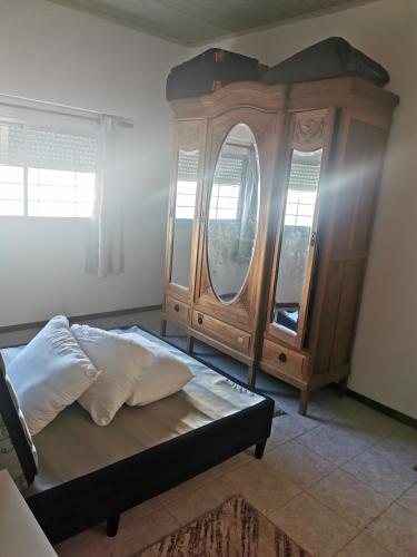 a bedroom with a bed and a wooden dresser at La Abuelita in Rocha