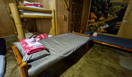 a room with a bunk bed in a room with a mirror at J Travel Trail Homestay in Hubangon, Camiguin in Camiguin