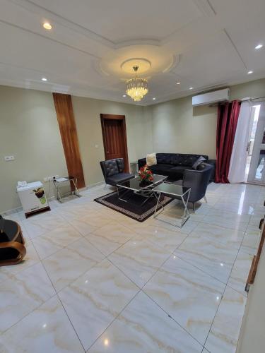 a living room with a couch and a table at Safyad Hotel in Yaoundé