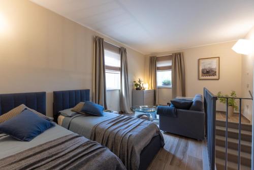 a hotel room with two beds and a couch at Guest House Ferri e Zani in Cavatore