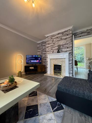 a living room with a couch and a fireplace at Charming 3 BR - NEC HS2- Long Stays Wifi Parking Airport in Shirley