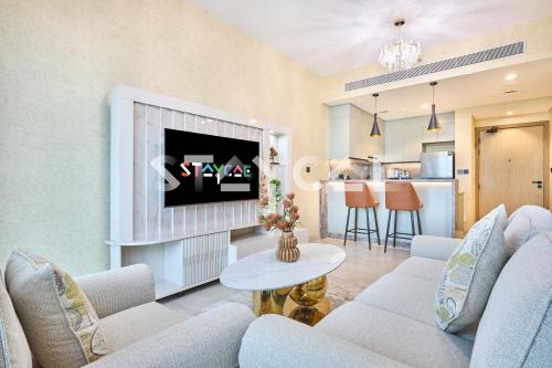 a living room with two couches and a tv at Staycae Holiday Homes Golf Gate - Damac Hills in Dubai