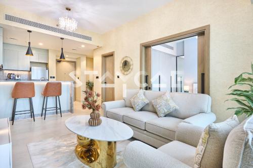 a living room with a couch and a table at Staycae Holiday Homes Golf Gate - Damac Hills in Dubai