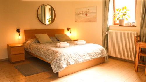 a bedroom with a bed with two towels on it at Casa Galya with private patio by GardaDoma in Brenzone sul Garda