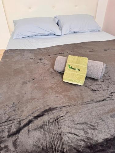 a bed with two towels on top of it at Comfy Hut-KLIA SEPANG in Sepang