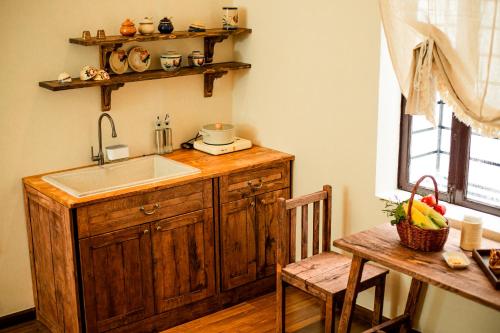 a kitchen with a sink and a counter with a table at Nàng Homestay Studio in Thu Dau Mot