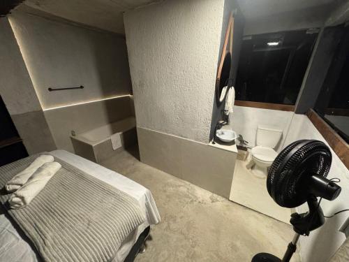 a hospital room with a bed and a toilet at Mirante de itaipava in Itaipava