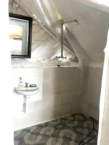 a bathroom with a sink and a mirror at TREE HOUSE Lodge in Gilgil