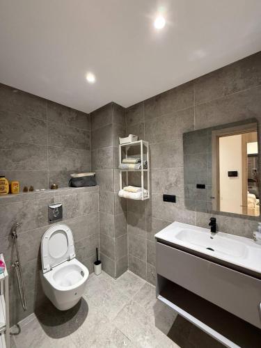 a bathroom with a toilet and a sink at Appartement a Malabata hills in Tangier