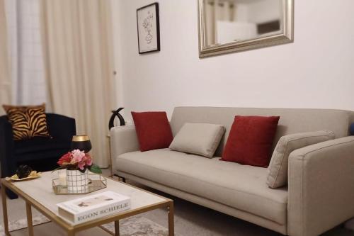 a living room with a couch and a table at 2 Bed House Sleeps 4 - Private Garden Parking in Coventry