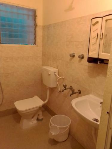 a bathroom with a toilet and a sink at zest homes in Chennai