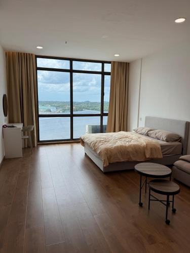 a bedroom with a bed and a large window at The Calm Corner Summermall in Kota Samarahan