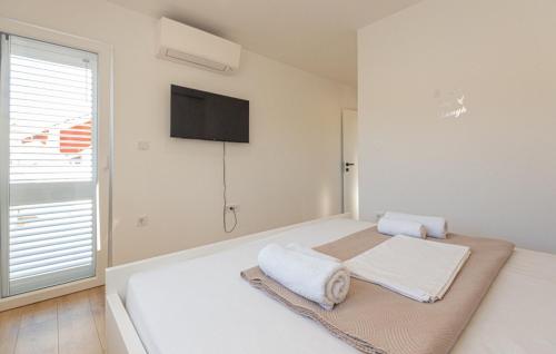 a bedroom with a bed with a tv on the wall at Holiday home Iva by Villas Guide in Vrulje