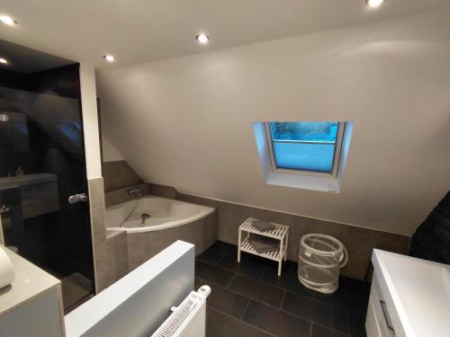 a bathroom with a tub and a sink at Waeller-Home in Dernbach