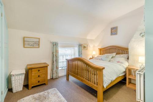 a bedroom with a wooden bed and a window at 2 Bed in East Rudham oc-t33378 in East Rudham